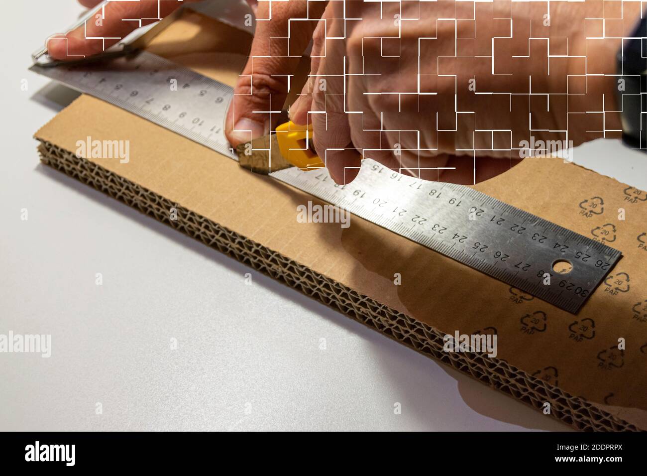 Cutting cardboard with a blade and ruler Stock Photo Alamy