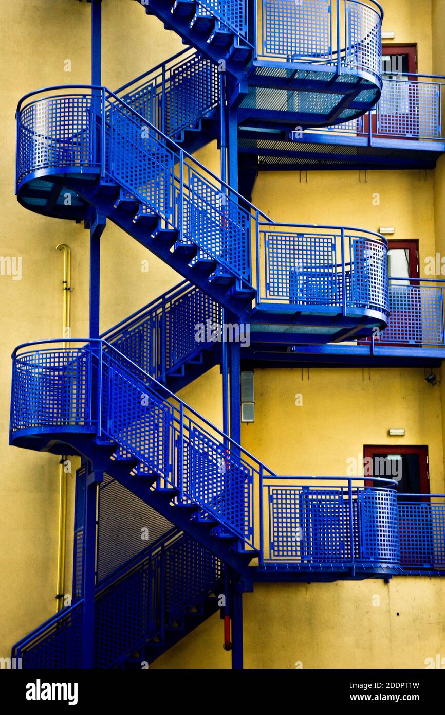 blue modern metal stairs on a yellow building Stock Photo