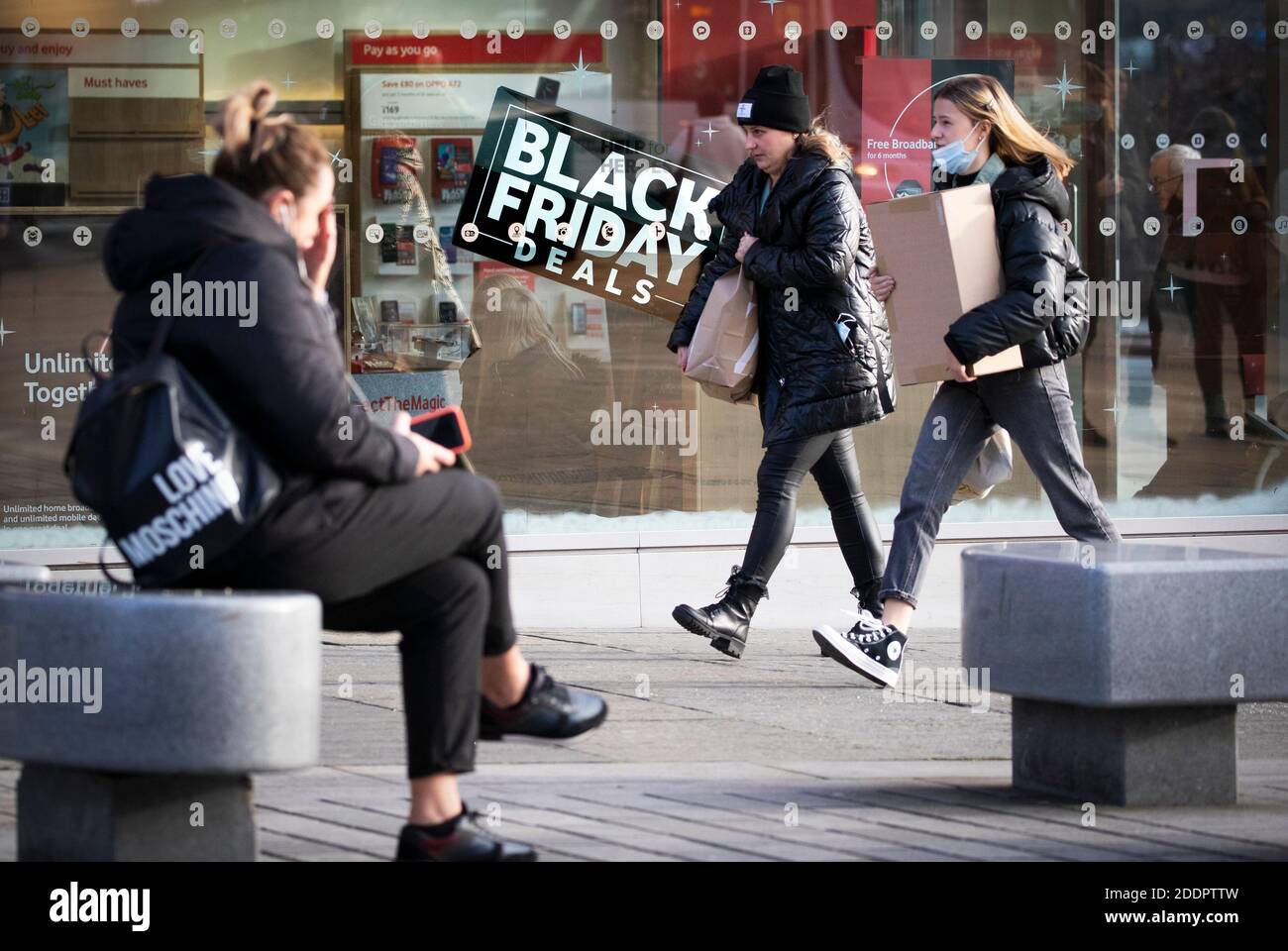 Shops along Princes Street in Edinburgh display posters and signs