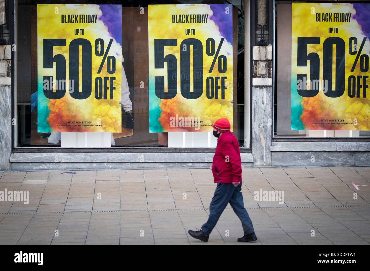 Shops along Princes Street in Edinburgh display posters and signs