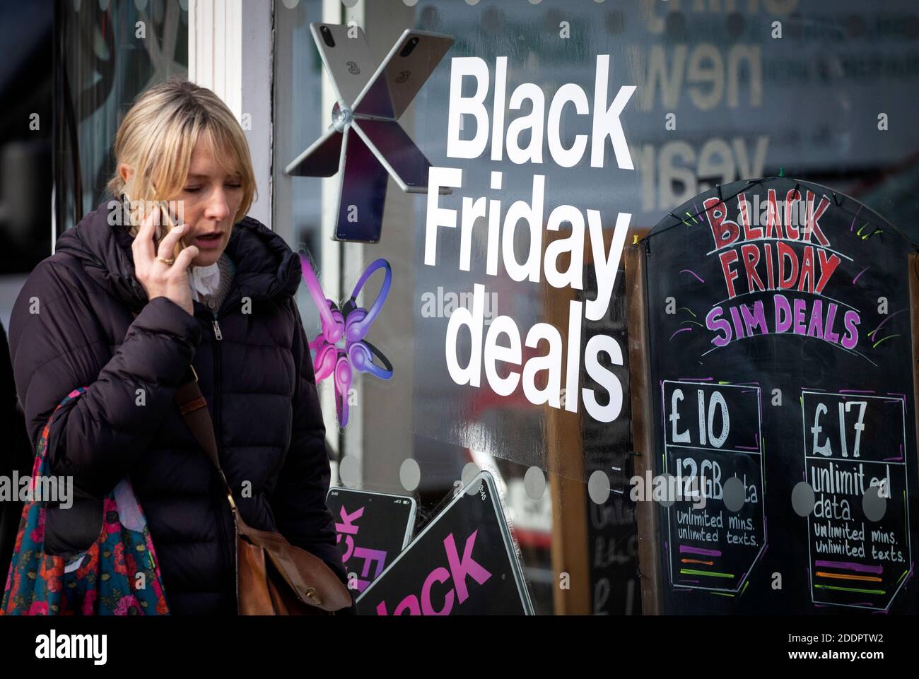 Shops along Princes Street in Edinburgh display posters and signs