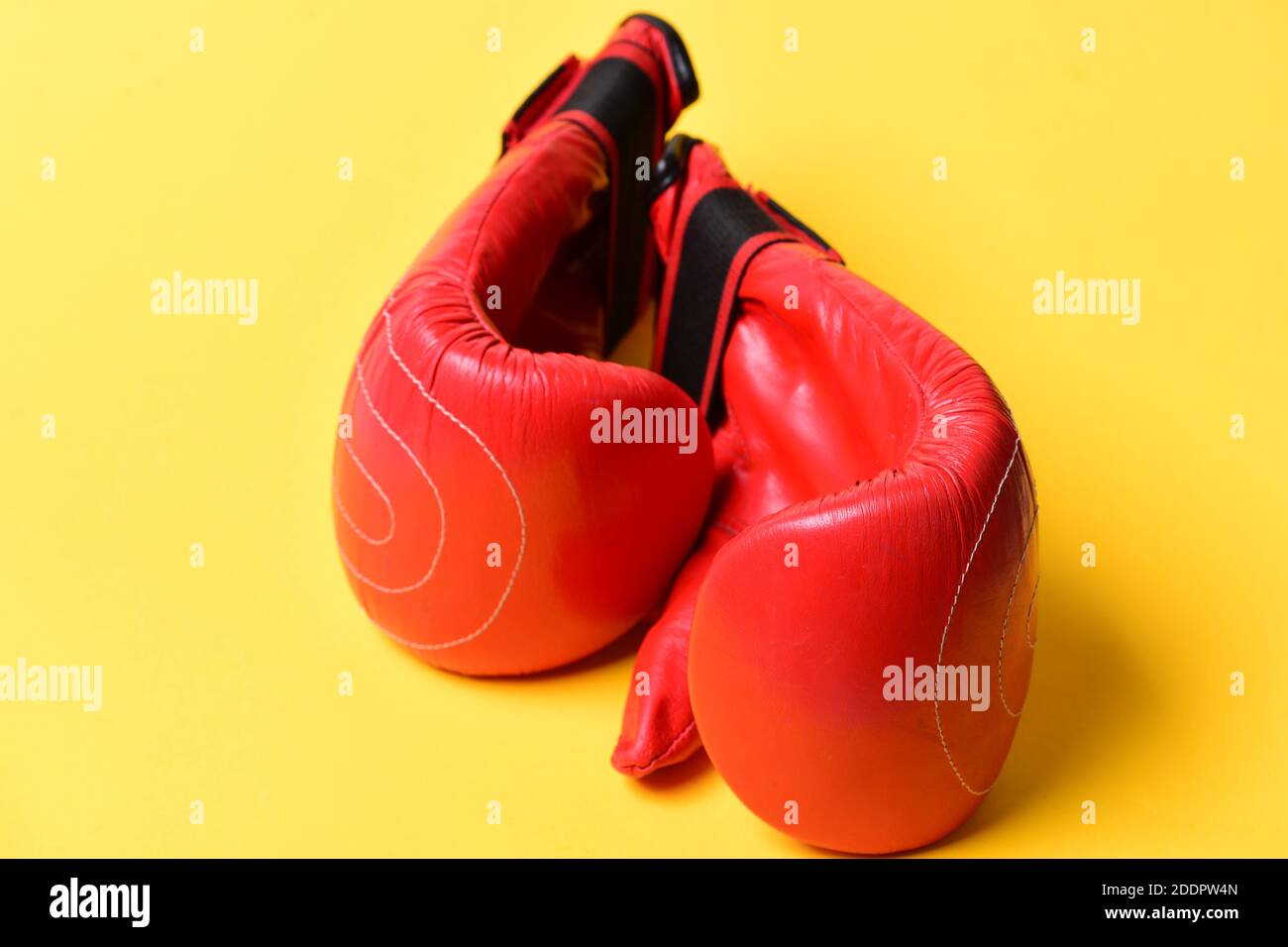 Pair of boxing gloves lying next to each other. Leather box equipment for fight and training