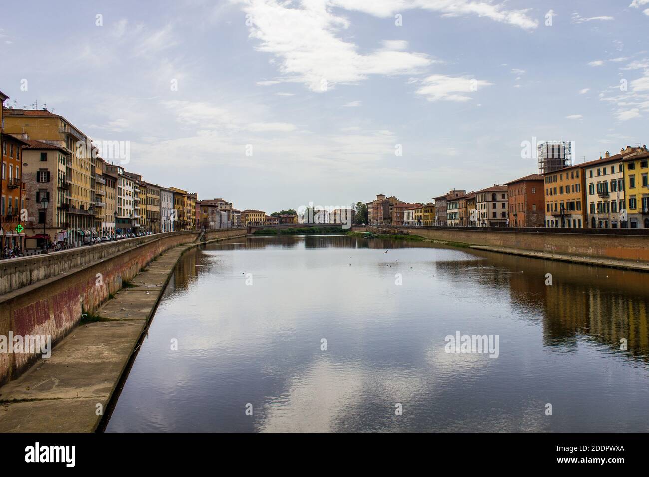 Pisa, Italy - July 9, 2017: View of People Walking along Arno River on a Summer Day Stock Photo
