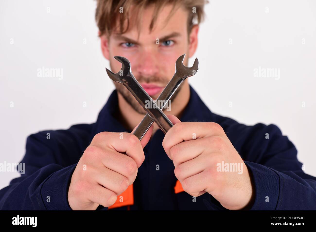 Spanner instrument for fixing or tightening details. Man with serious