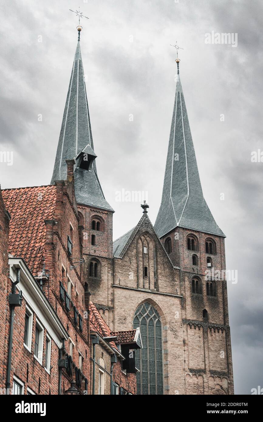 The towers of De Sint Nicolaaskerk or Bergkerk in Deventer is originally a Romanesque cross basilica Stock Photo