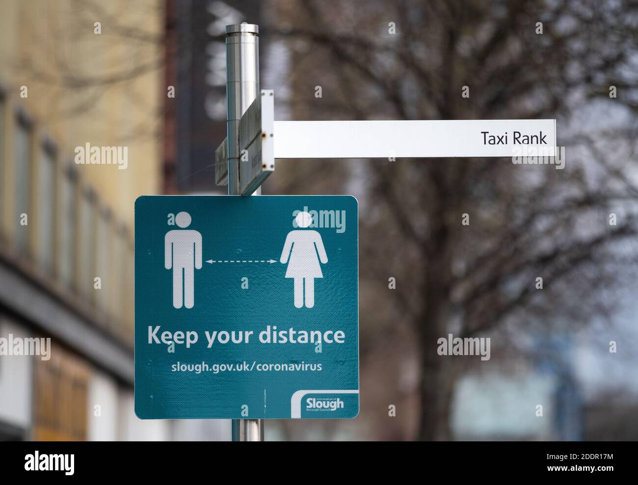 A social distancing sign on the High street in Slough, Berkshire, in ...