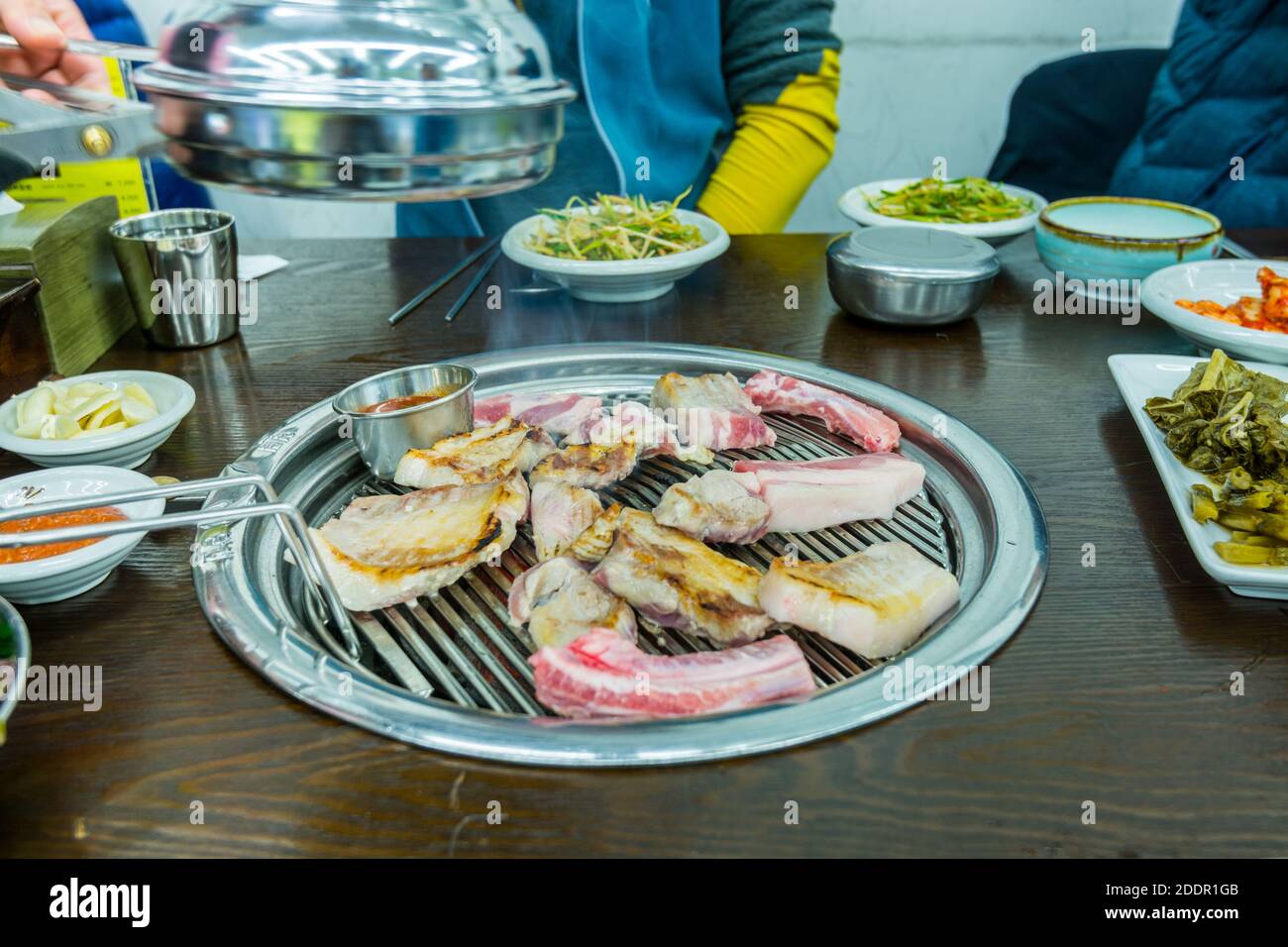Korean food, grilled pork barbecue on hot metal plate looks tasty and
