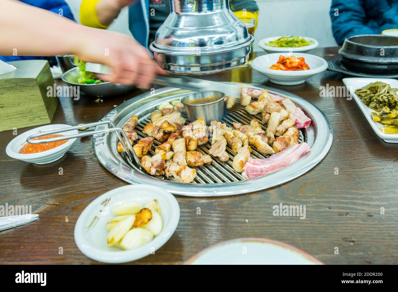 Korean food, grilled pork barbecue on hot metal plate looks tasty and