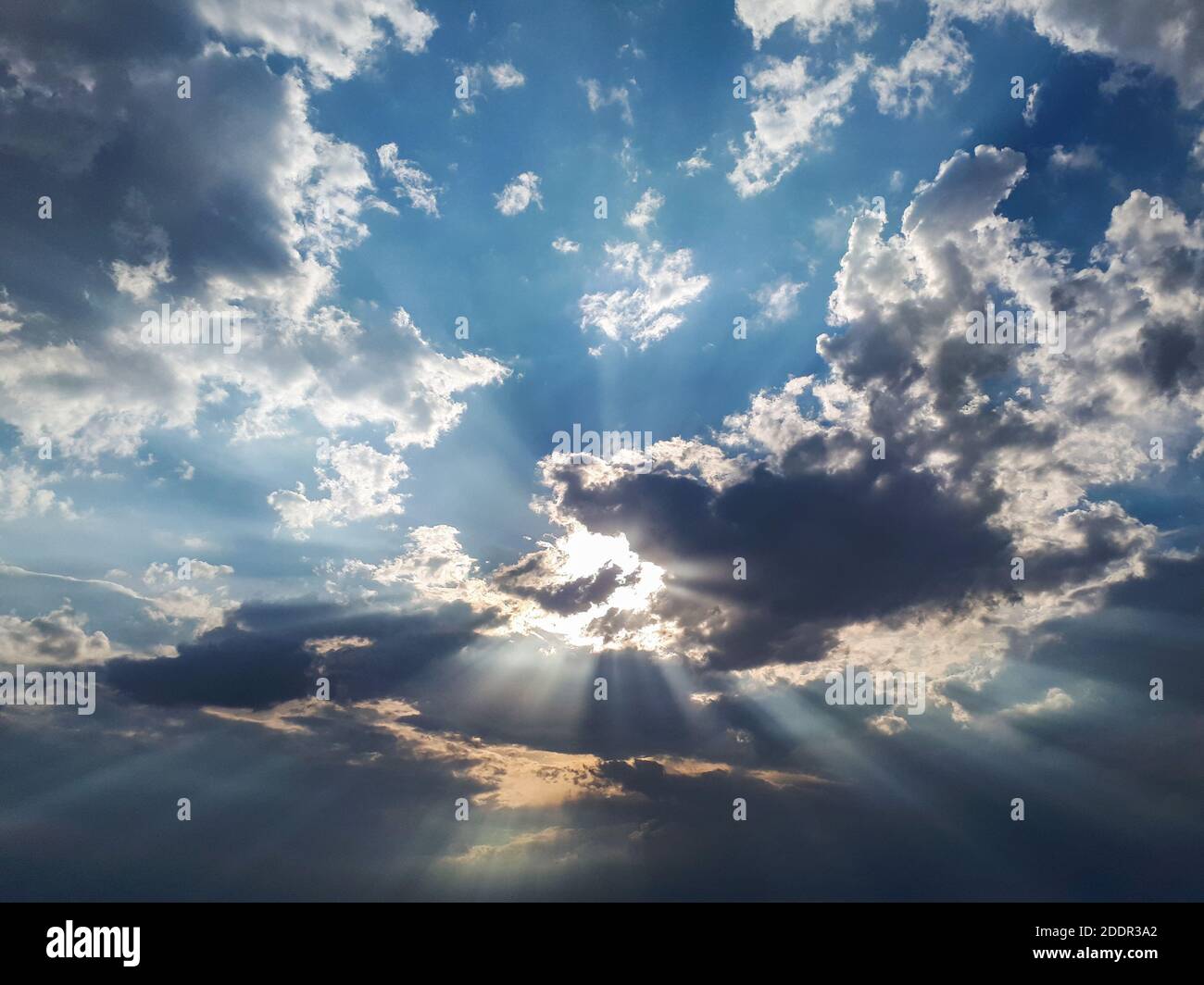 A low angle shot of a blue cloudy sky and bright sunlight at daytime ...