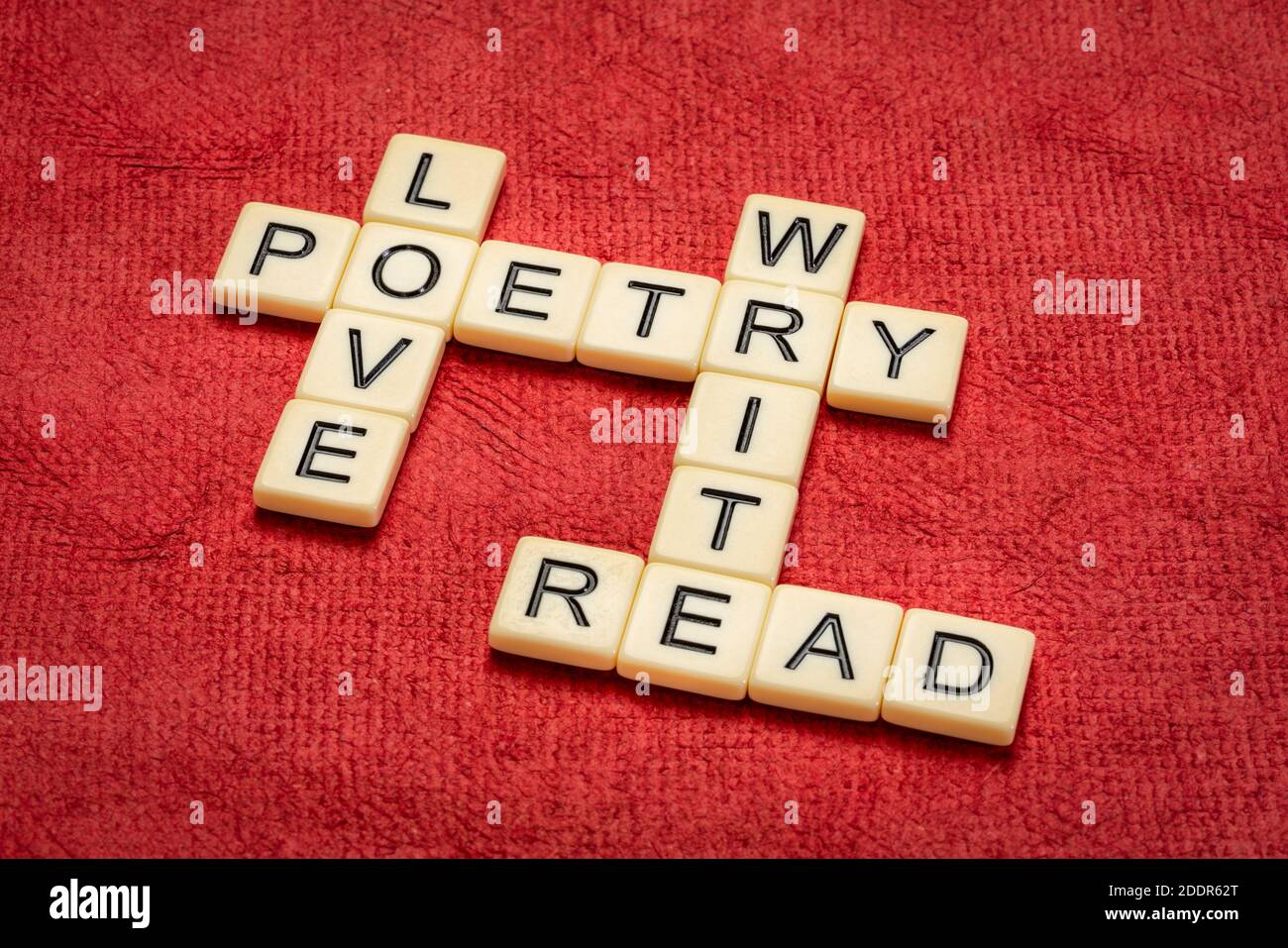 love, read, write poetry crossword in ivory letter tiles against