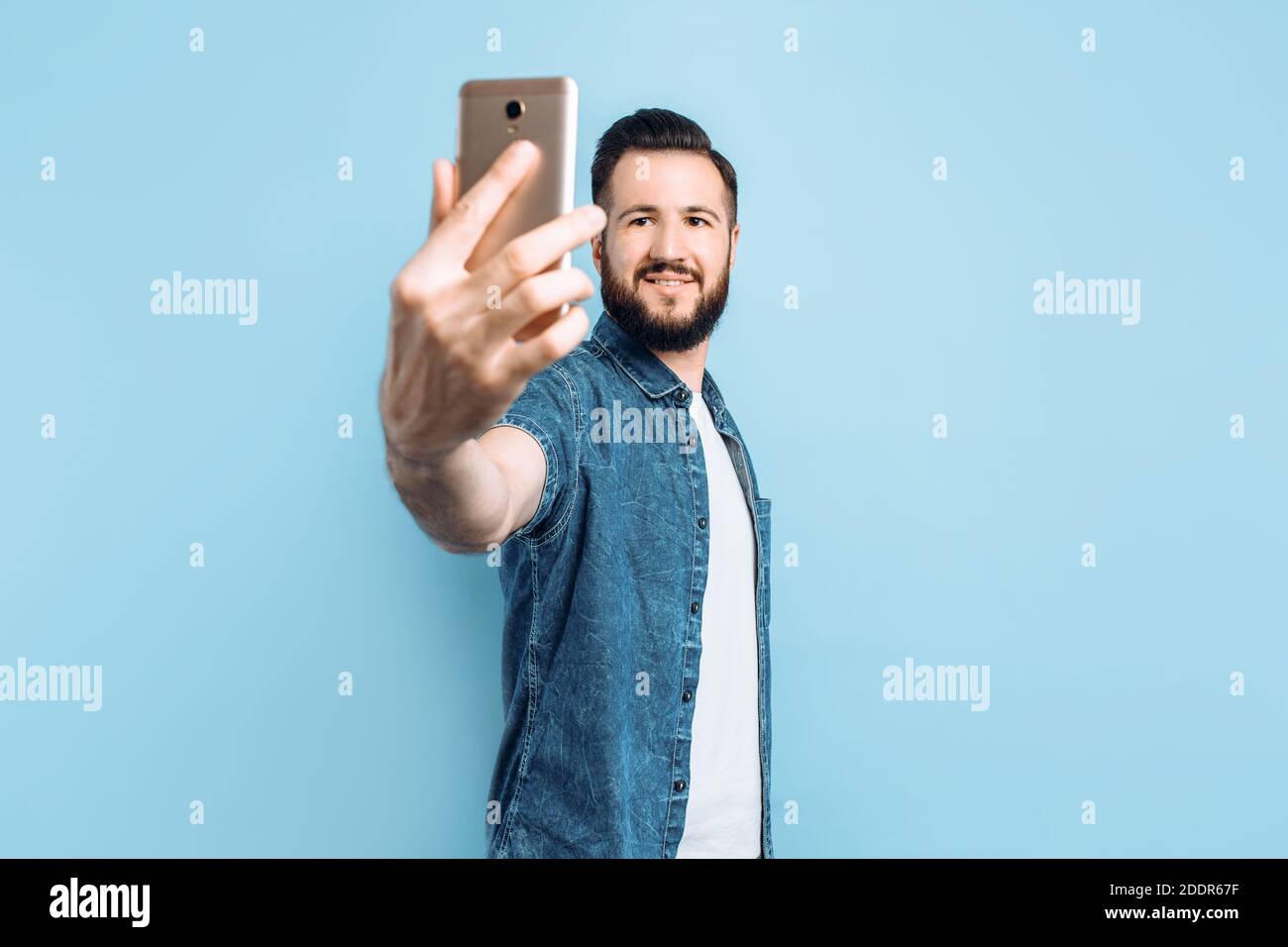 Happy fashionable man with a beard in casual clothes, smiling and ...