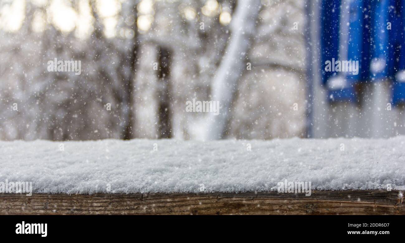 Empty wooden table snow covered with rustic winter landscape background ...