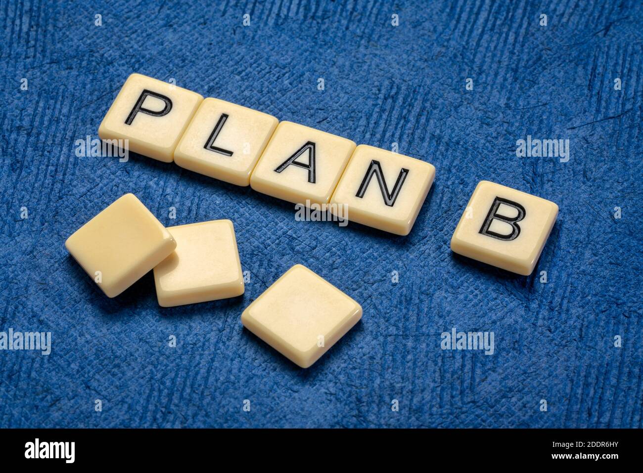 plan B text in ivory letter tiles against textured handmade paper, revision and changing business or personal plans and goals concept Stock Photo