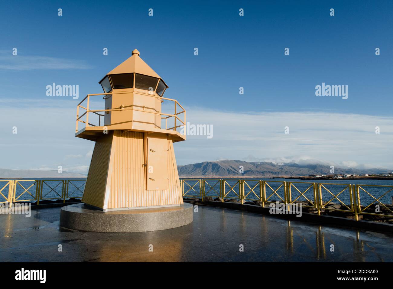 A typical yellow lighthouse and lookout on the shoreline of the city of Reykjavík, Iceland Stock Photo