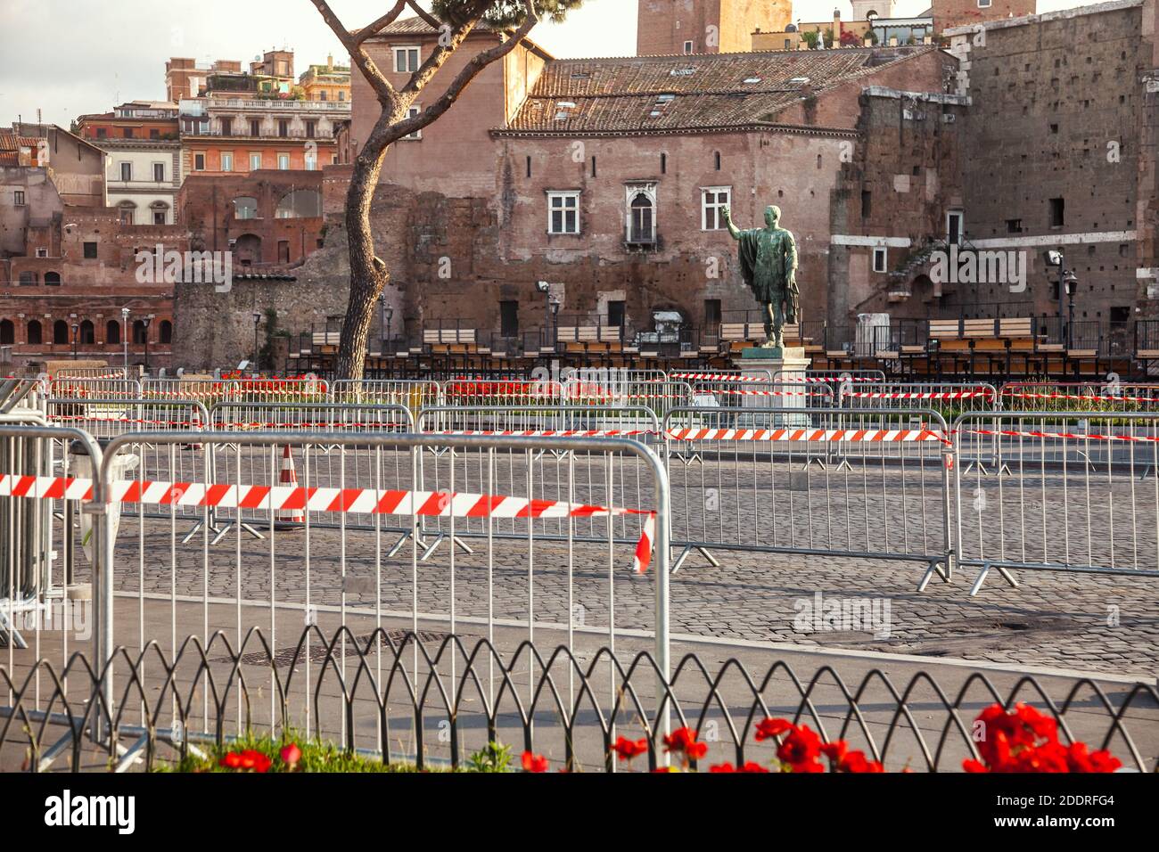 Road barriers with red-and-white warning tape blocking the Via dei Fori Imperiali road at Rome, Italy - lockdown due to Coronavirus COVID-19 pandemic Stock Photo