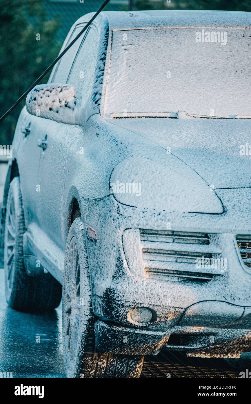 washing the car. Washing a black car at a car wash. Clean car Stock