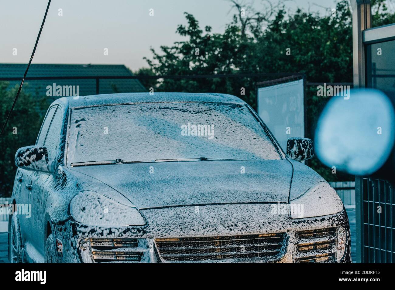 washing the car. Washing a black car at a car wash. Clean car Stock