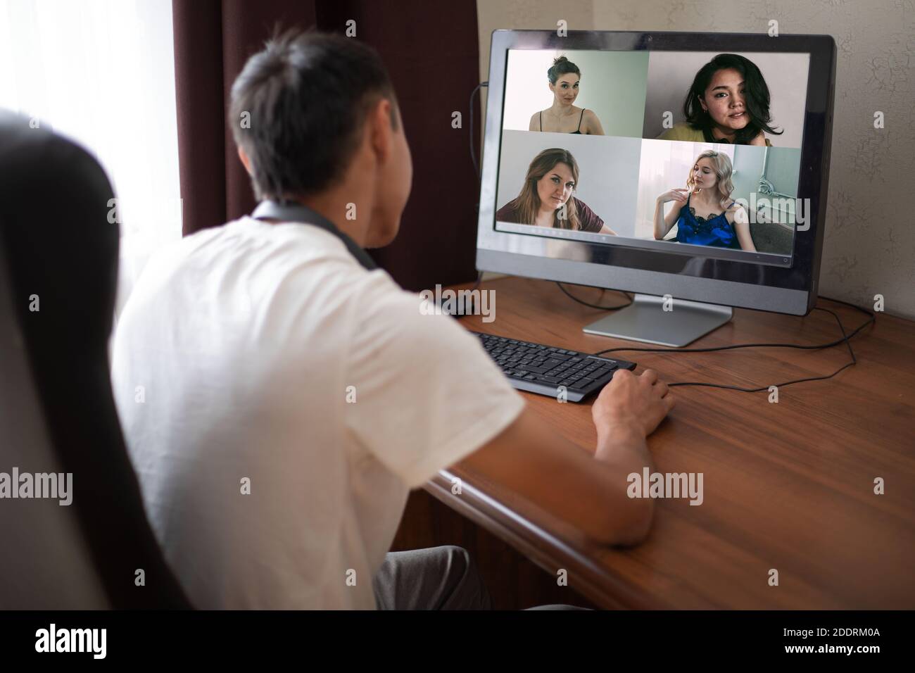 Back view of businessman talking to his colleagues about plan in video conference. Multiethnic business team using laptop. Group of people smart worki Stock Photo
