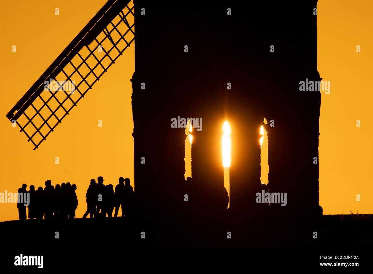 People gather to watch sunset by Chesterton Windmill in Warwickshire. Stock Photo