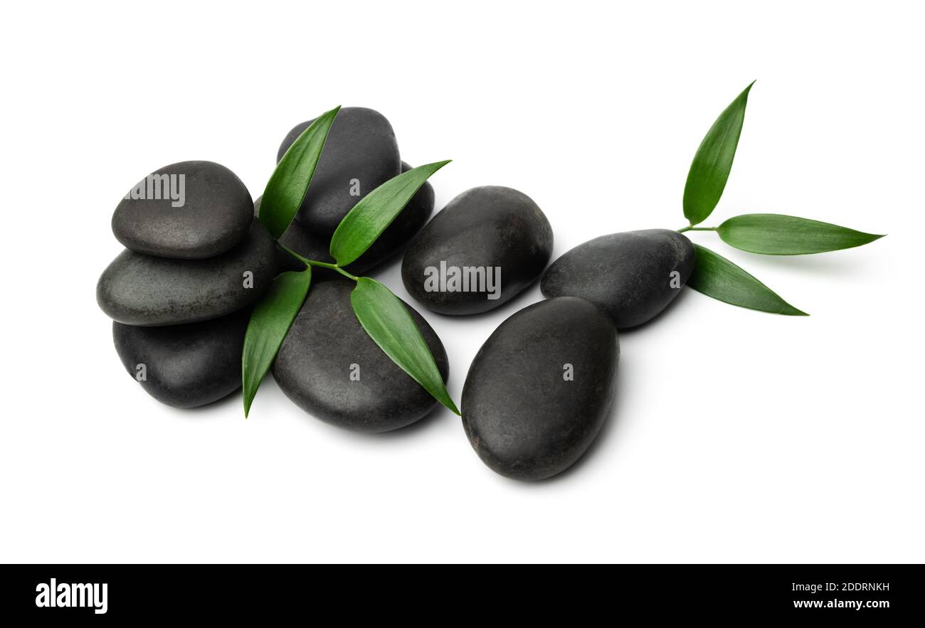 massage stones isolated on white background with green leaf. lastone therapy Stock Photo