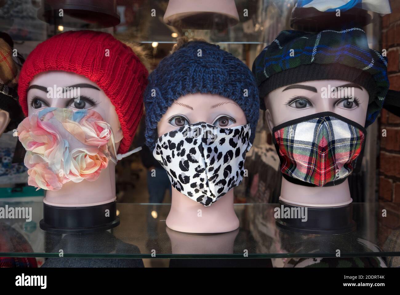 Mannequins wearing face masks in the window of a shop on Princes Street, Edinburgh, Scotland, UK. Stock Photo