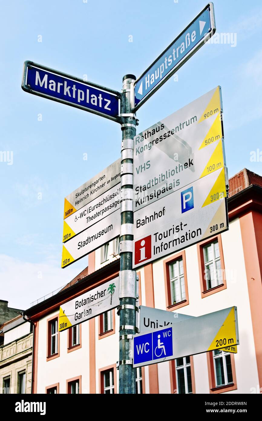 Directional signs on the pole in the city center. Stock Photo