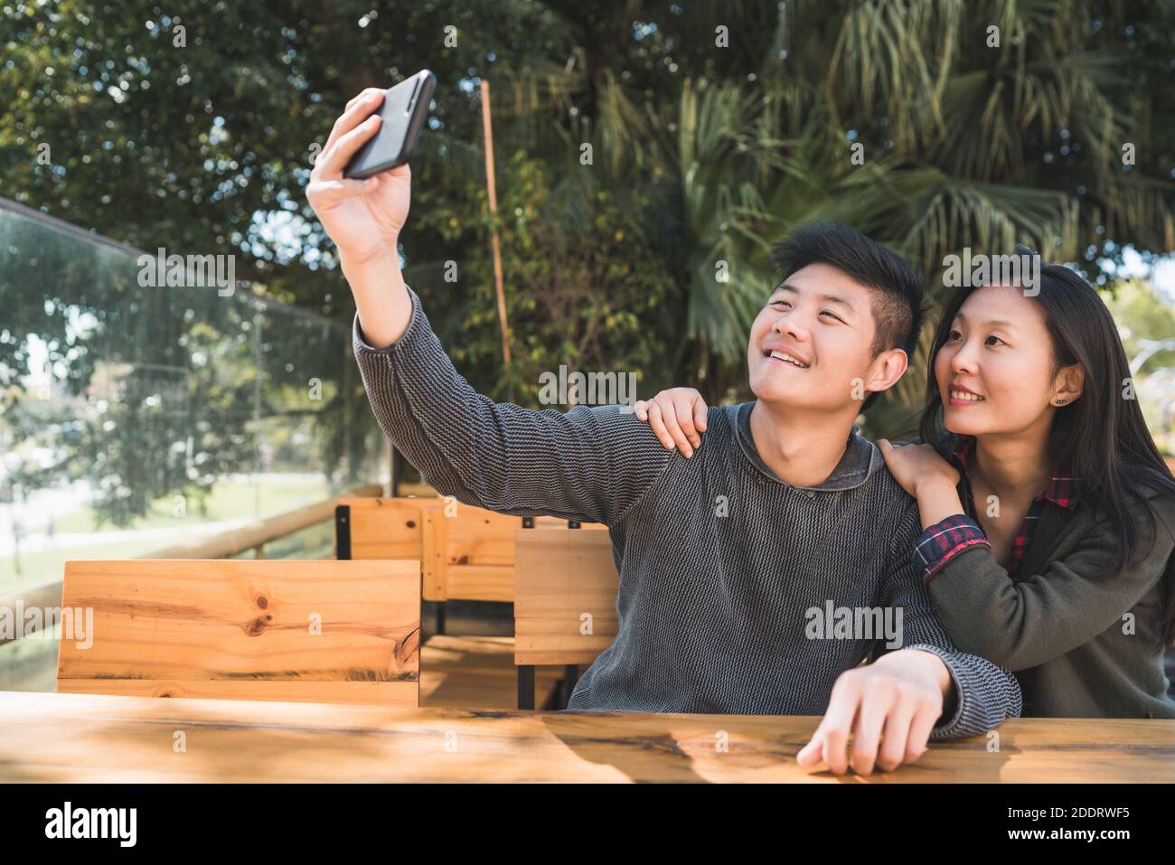 Asian couple taking a selfie with mobile phone Stock Photo - Alamy