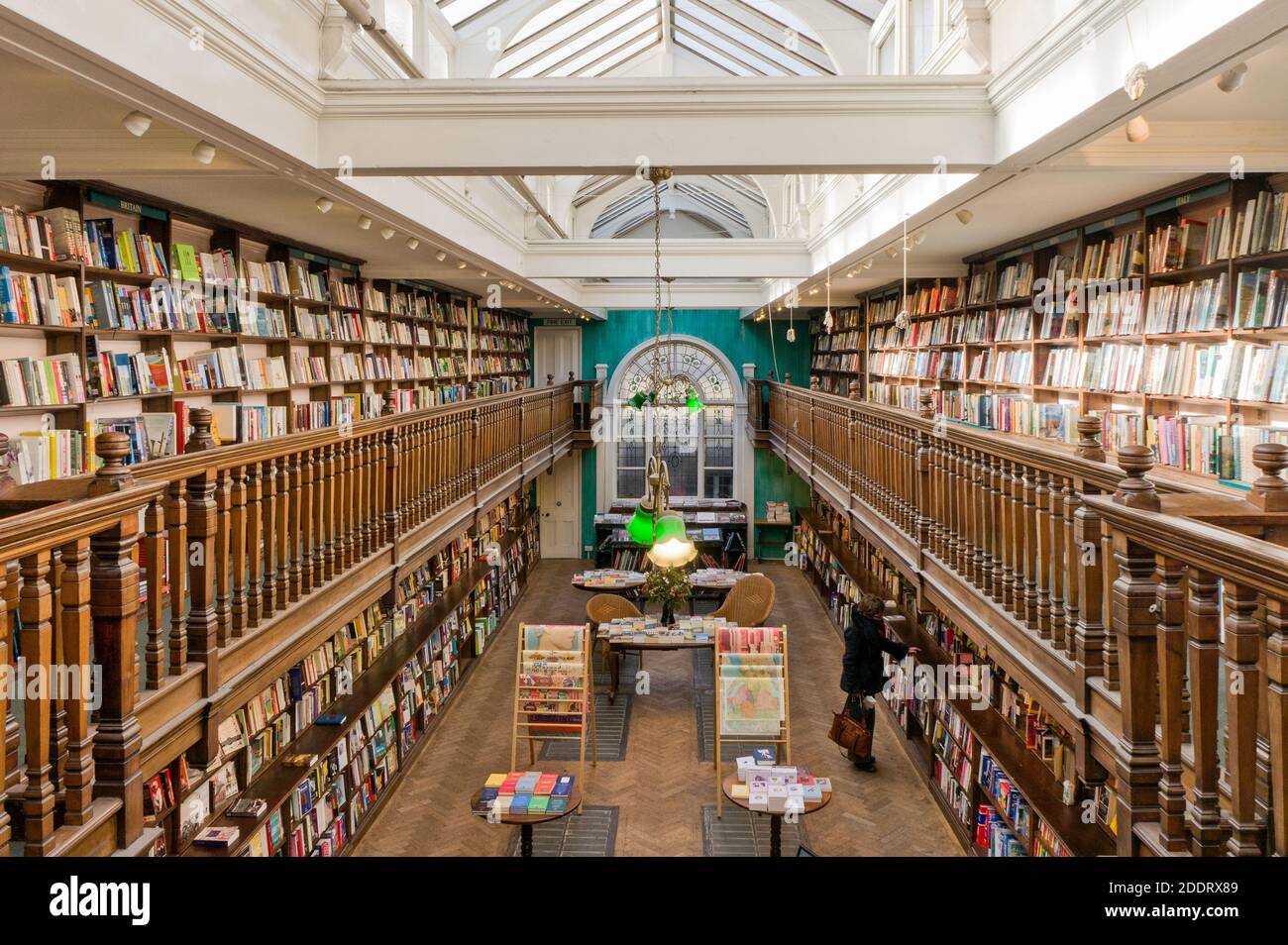 Interior of Daunt Books, Marylebone, London, UK; woman browsing books. Stock Photo