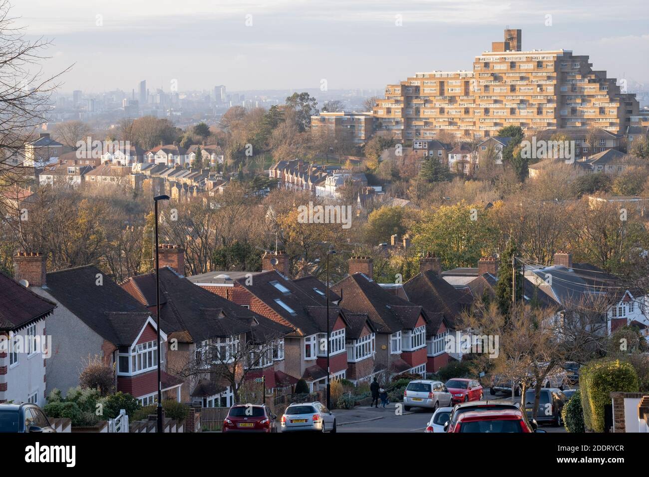 Suburban homes, flats and parked cars with a cityscape looking north from Horniman Hill towards the prominent residential complex of Dawson Heights in East Dulwich, on 23rd November 2020, in London, England. Stock Photo