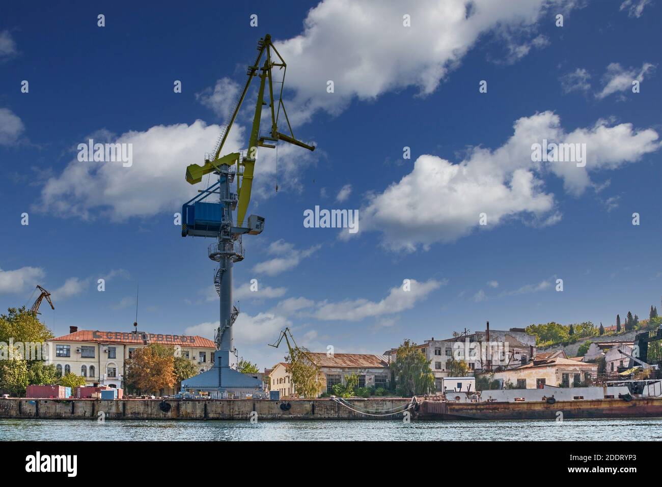 Sevastopol, Russia - September 26, 2020: Crane on the background of old buildings of the Sevastopol Marine Plant named after Sergo Ordzhonikidze Stock Photo