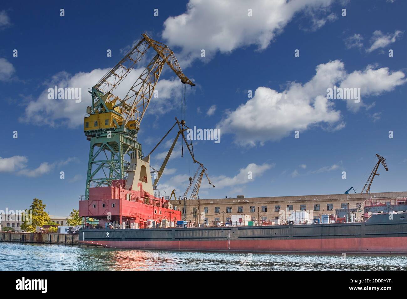 Crane on the background of old buildings of the Sevastopol Marine Plant named after Sergo Ordzhonikidze Stock Photo