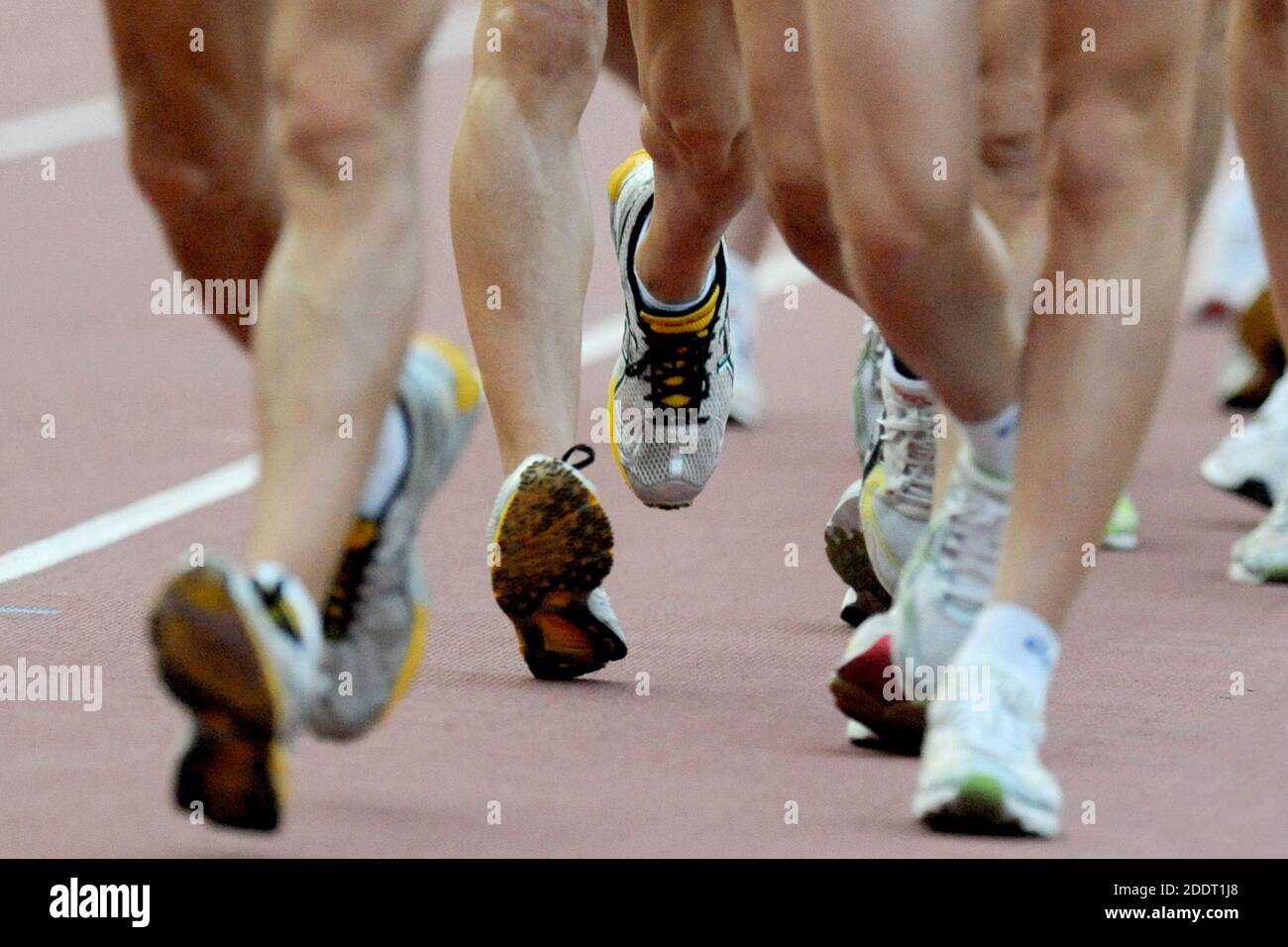 Athletes marchers competing in an outdoor athletics track at the Arena of Milan, Italy. Stock Photo