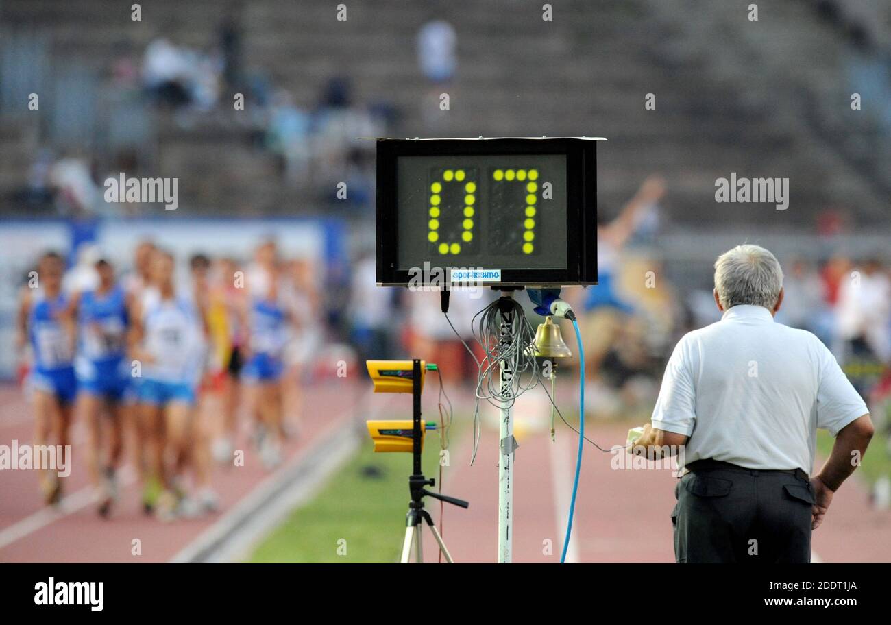 Athletes marchers competing in an outdoor athletics track at the Arena of Milan, Italy. Stock Photo