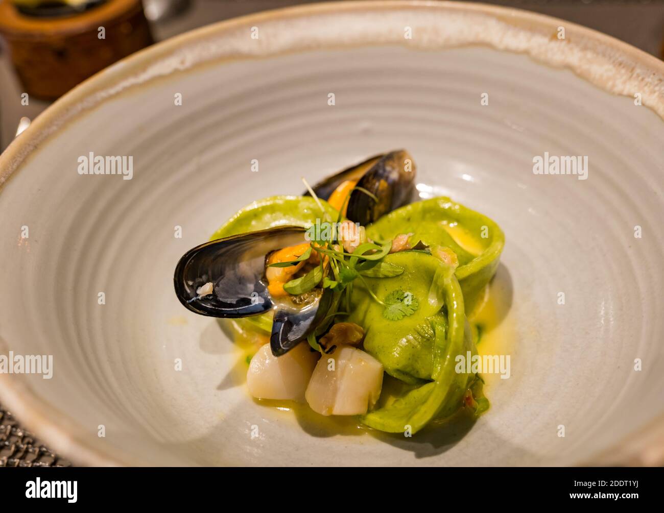 Michelin star fine dining plate of food: scallops and mussels with tortellini pasta Stock Photo