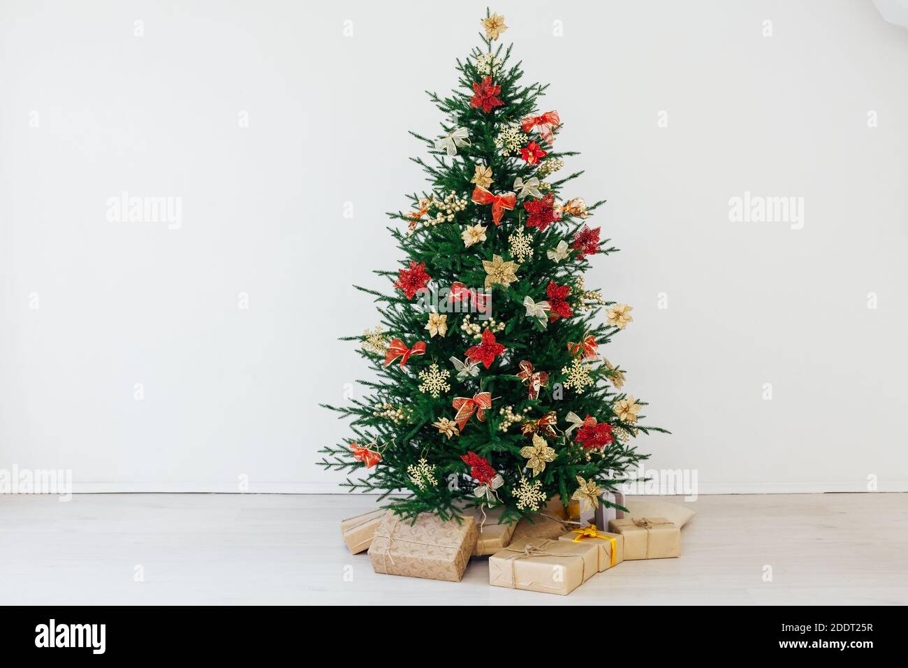 christmas tree with colorful balls and gift boxes over white wall Stock ...