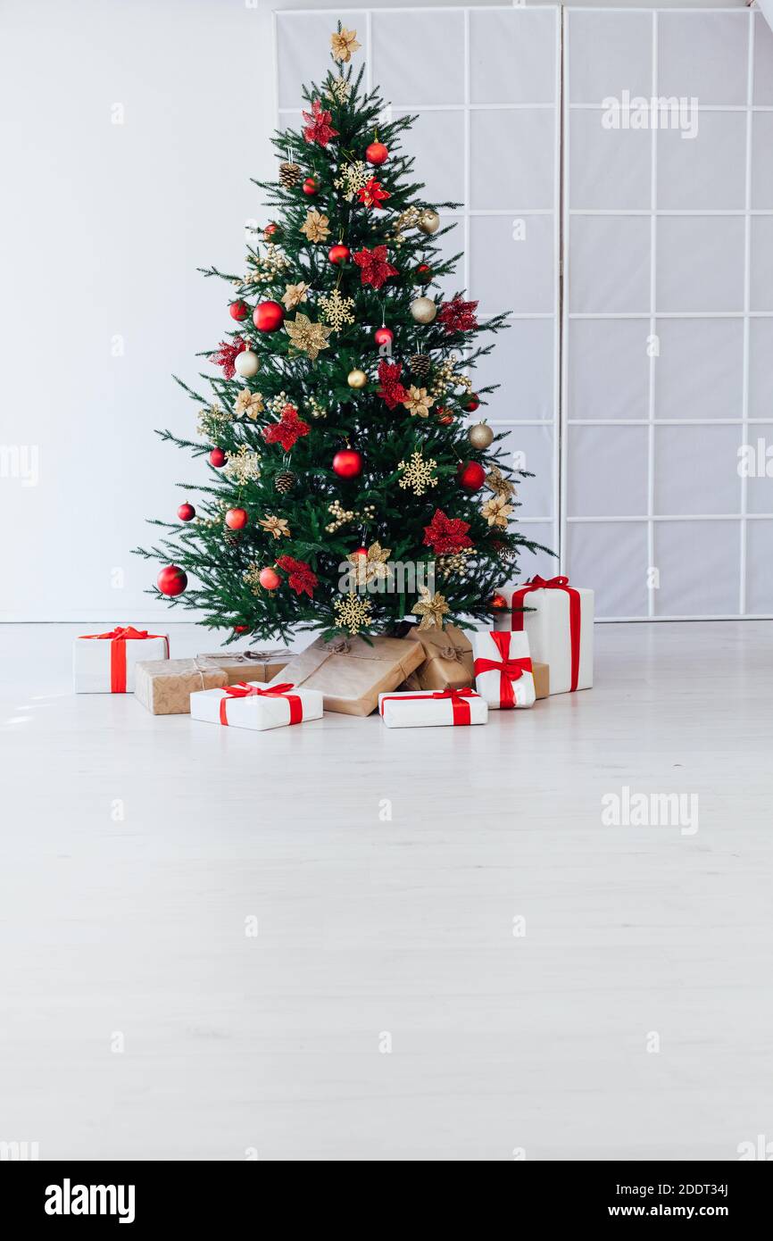 christmas tree with colorful balls and gift boxes over white wall Stock ...