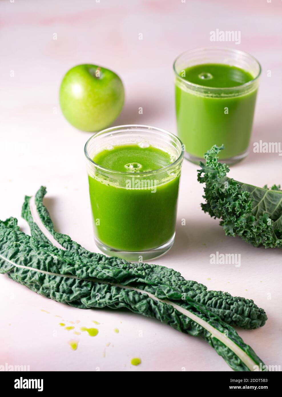 Two glasses of fresh green juice made from kale and green apples Stock Photo
