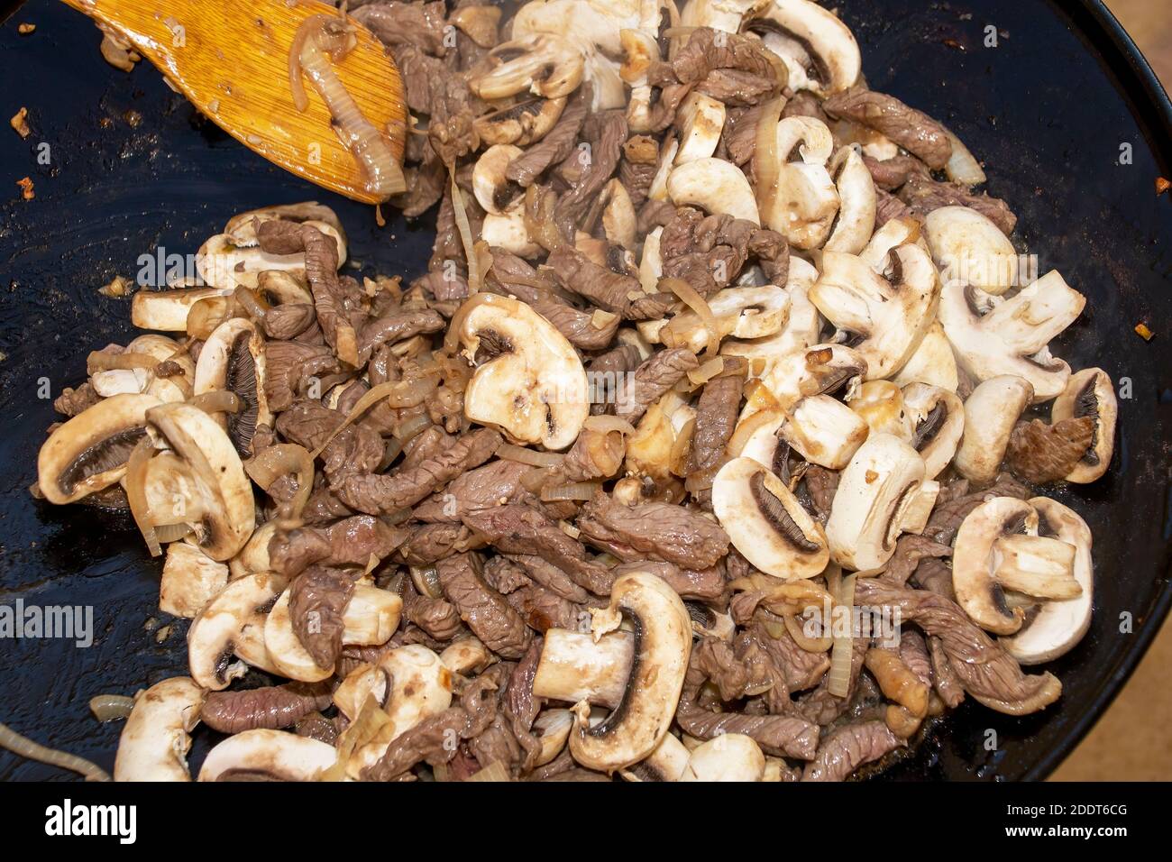 Closeup image of stir-fry being cooked on a camping gas cooker Stock Photo