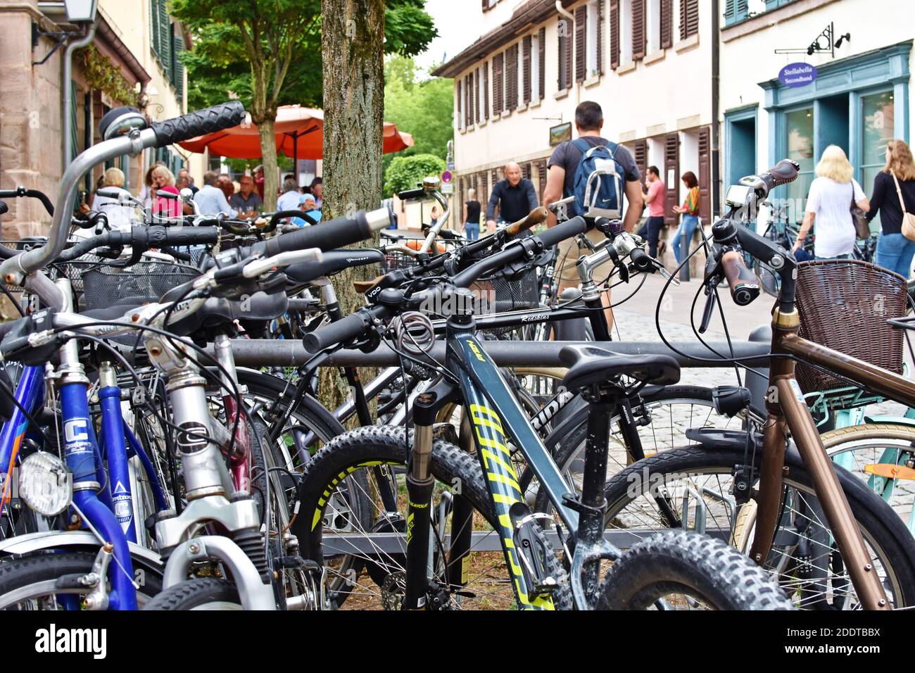 Photo of the street taken through many bicycles. Stock Photo