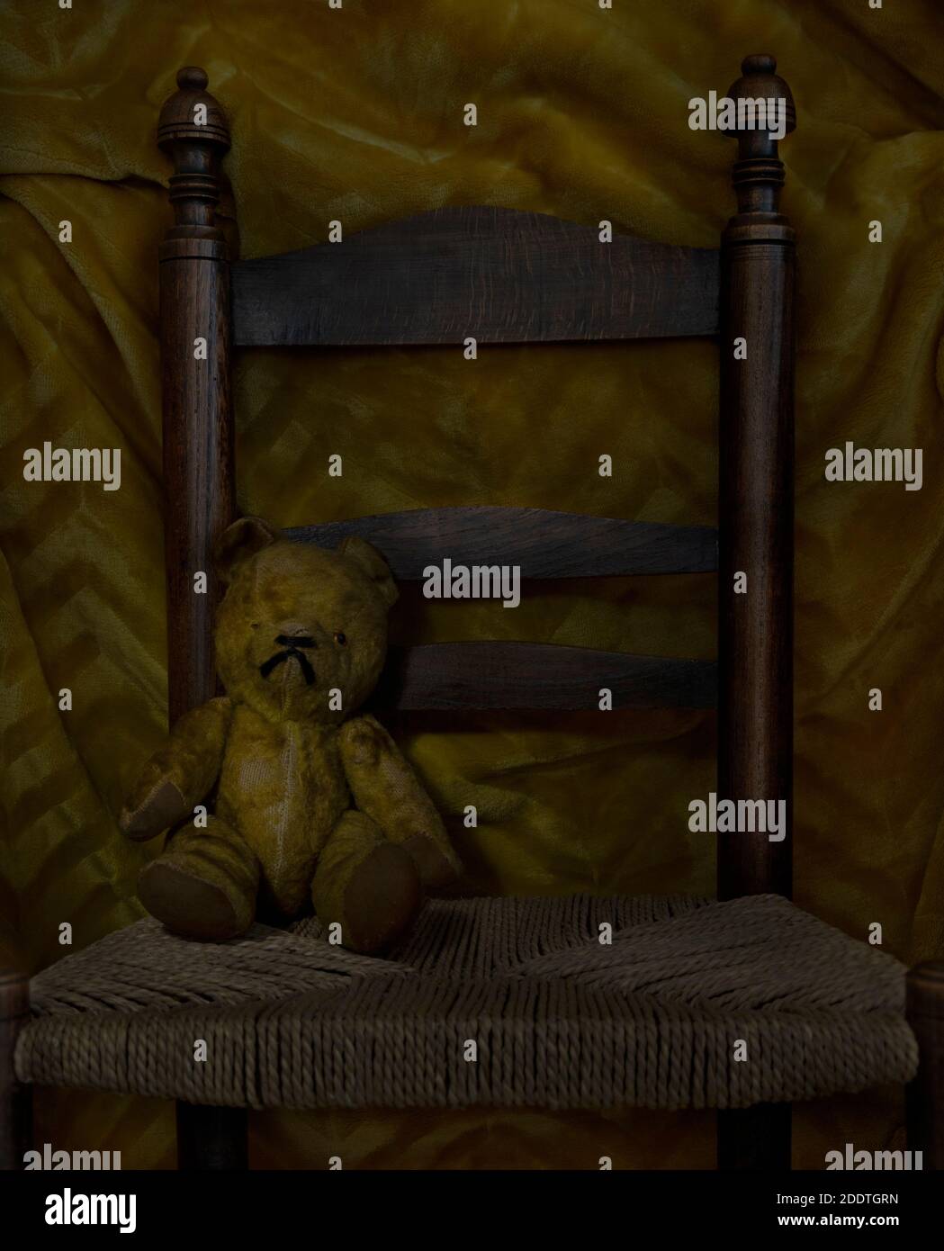 Yellow teddy sitting on wooden chair with material background Stock ...