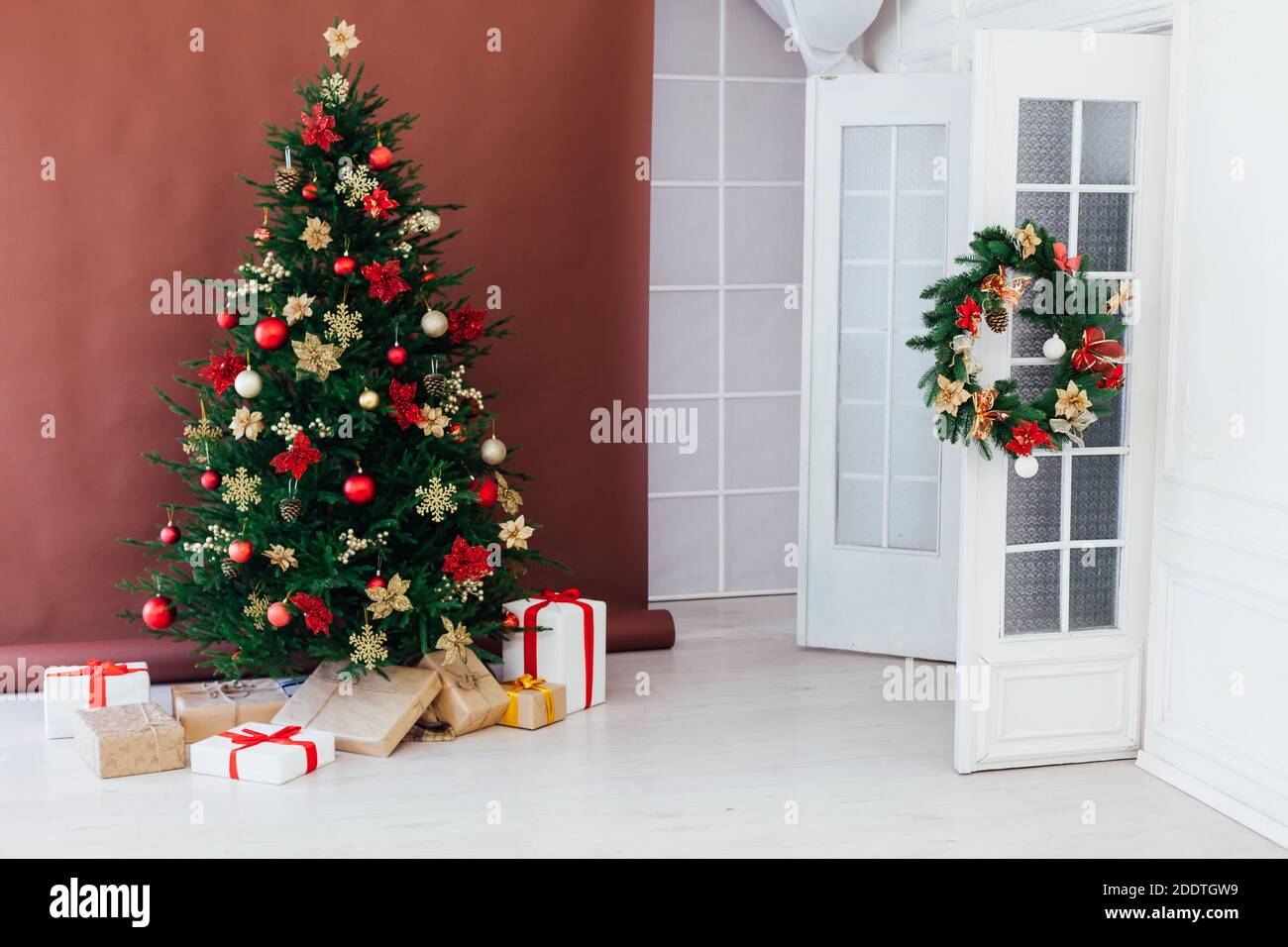 christmas tree with colorful balls and gift boxes over white wall Stock ...