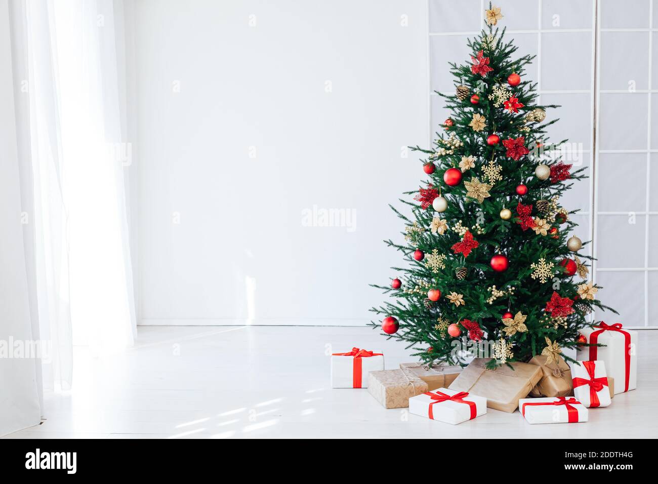 christmas tree with colorful balls and gift boxes over white wall Stock ...