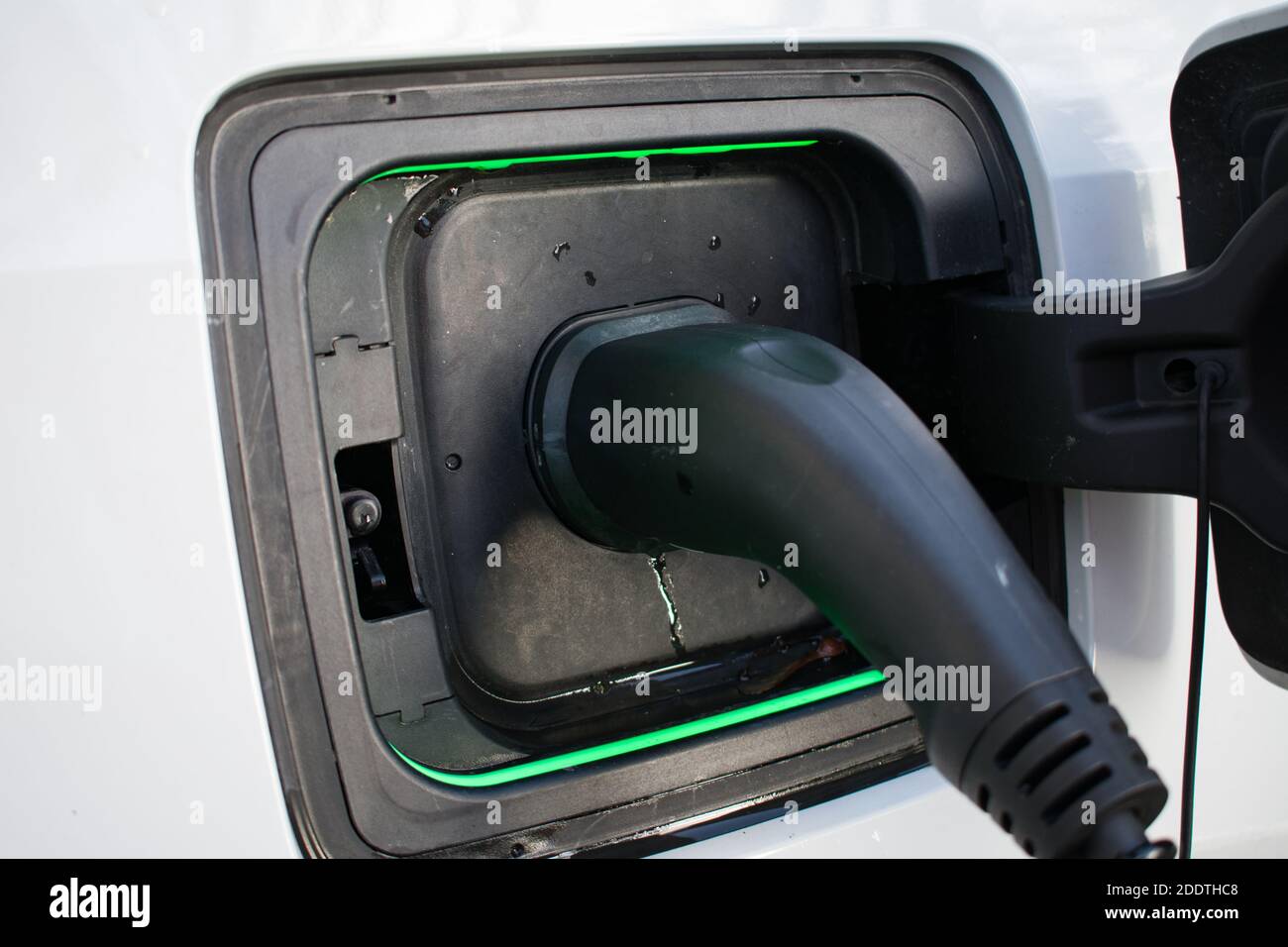 Electric Car Charger At Home Charging EV with lights on Stock Photo