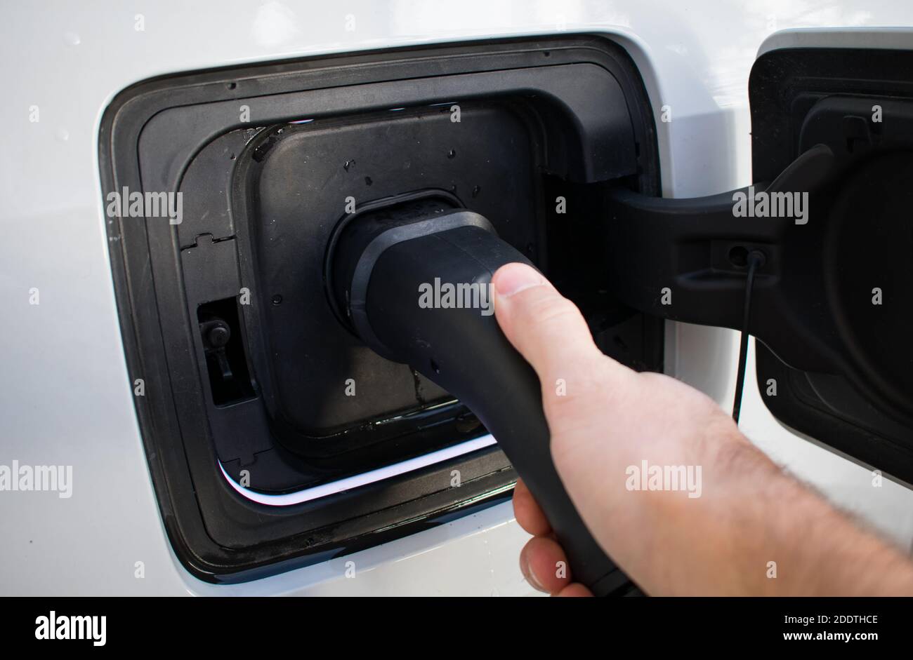 Electric Car Charger At Home Charging EV with lights on Stock Photo