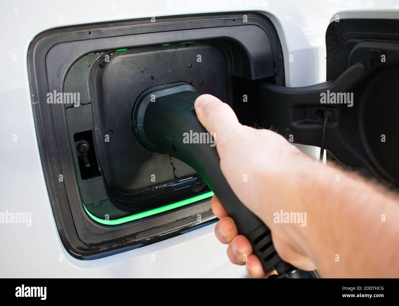Electric Car Charger At Home Charging EV with lights on Stock Photo