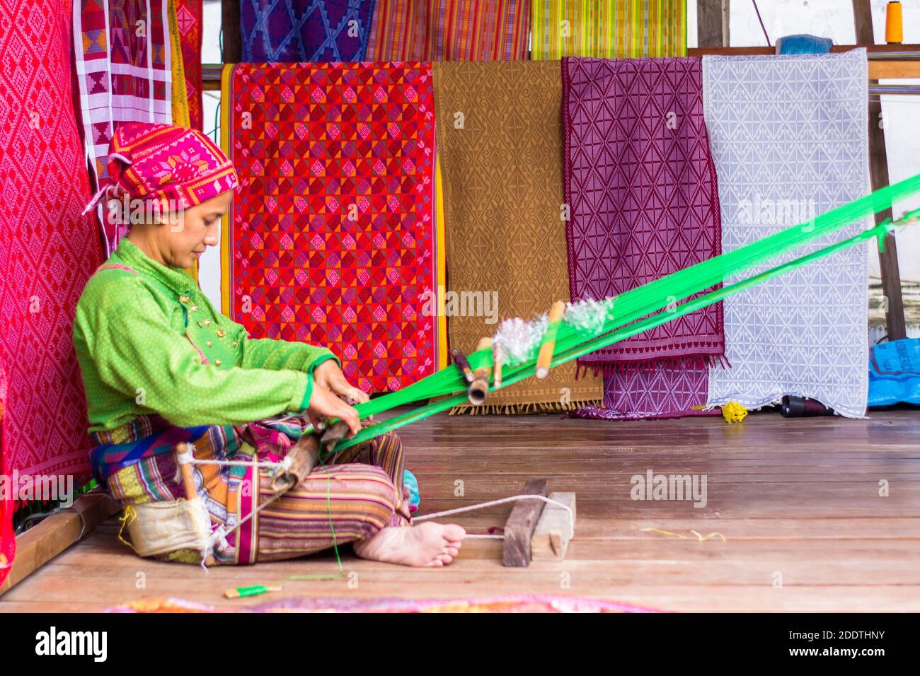 Evelinda Otong Hamja wearing traditional Yakan clothes weaving at the