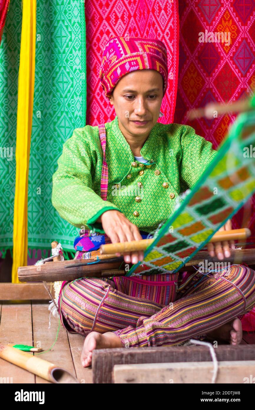 Evelinda Otong Hamja wearing traditional Yakan clothes weaving at the Yakan Weaving Center in