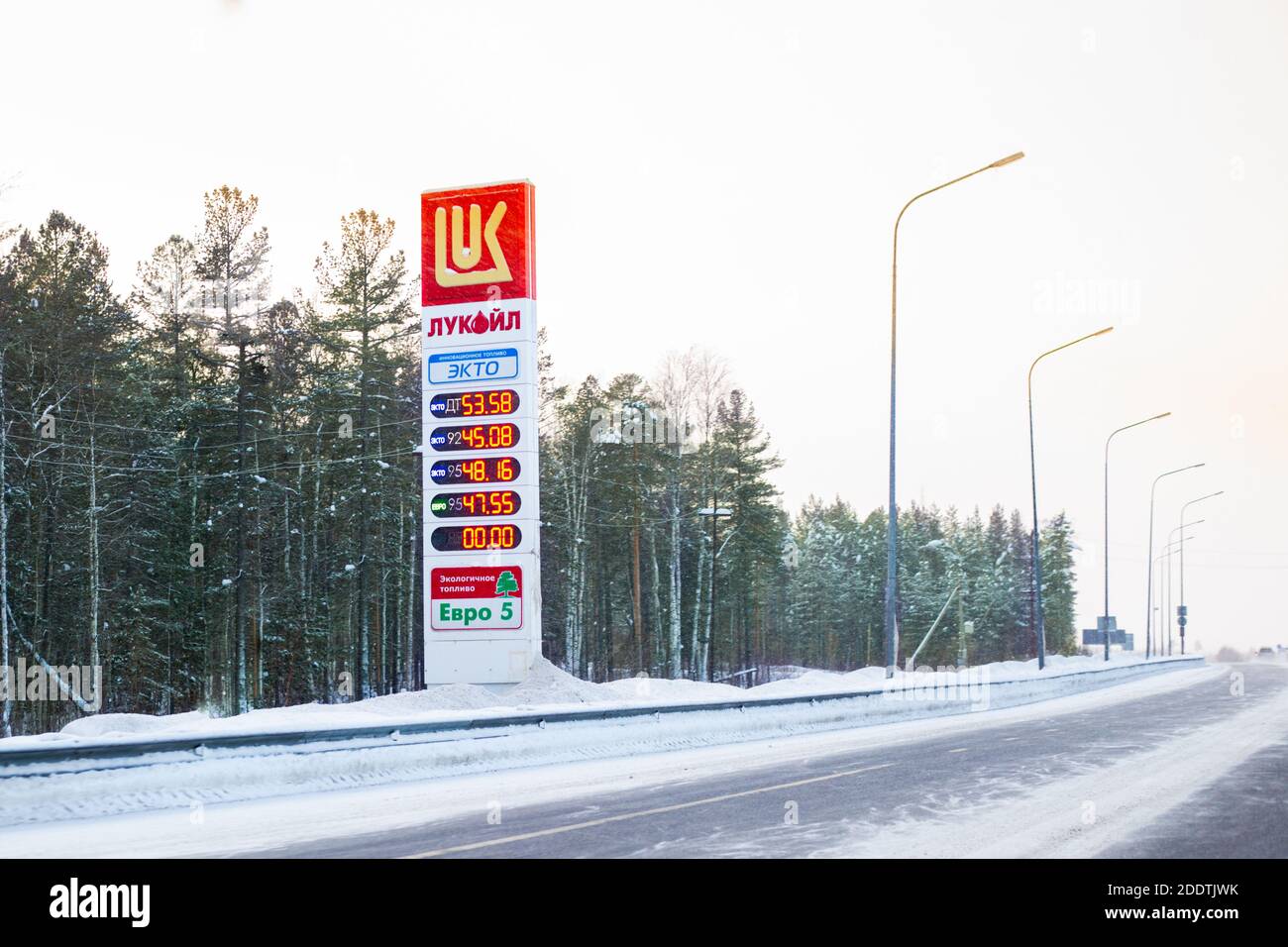 Surgut, Russia-01.25.2020: Information board of Lukoil gas station on the road, winter fuel prices.Ecological fuel transfer,blurred background Stock Photo