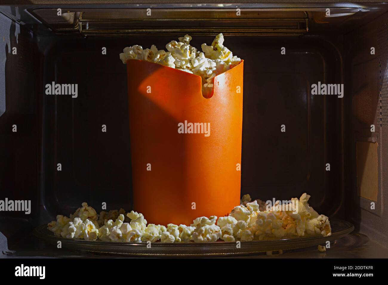 Orange silicon bucket filled with homemade cooked popcorn inside a