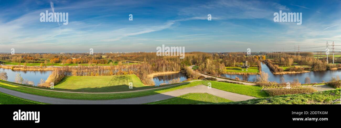 Panorama Landscape Park De Groene Weelde as seen from Big Spotters Hill in direction from west to north in bright autumn colors during sunrise Stock Photo